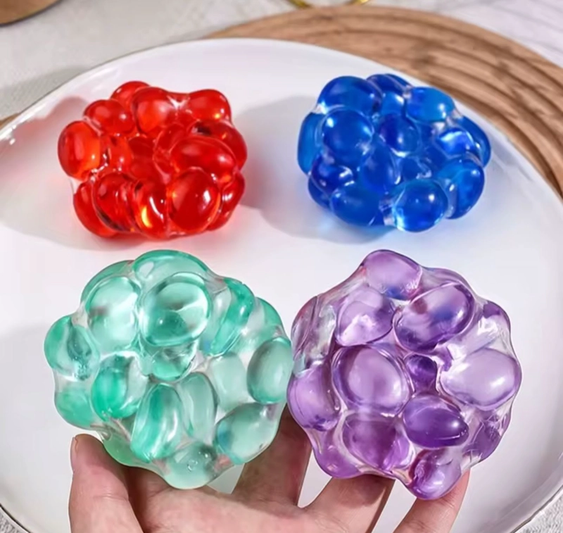 PELOTA SQUISHY ANTIESTRE S CON PIEDRAS SONORAS SENSORIAL - 1