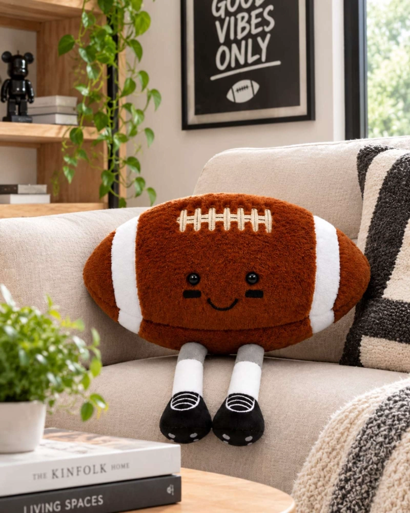 COJIN PELUCHE BALON FUTBOL AMERICANO CON PIERNAS PARA CUARTO INFANTIL - 1