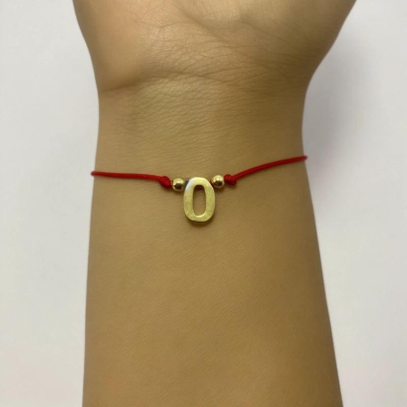PULSERA ANDREA COGGIOLA JOYAS LETRA O CORDÓN ROJO ENCHAPADO ORO 18K - 3