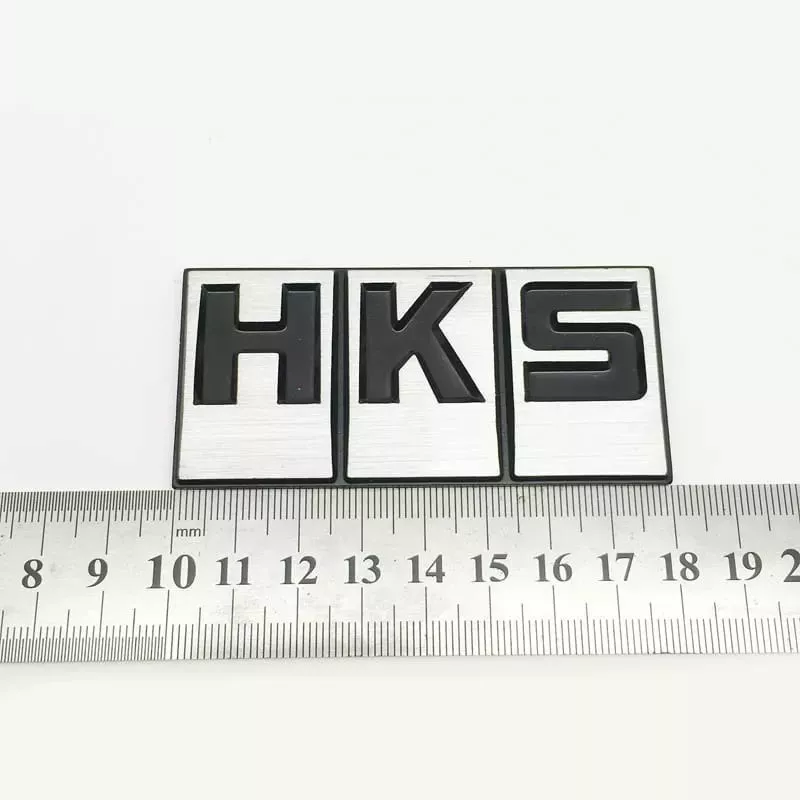 EMBLEMA PEGATINA ADHESIVO METÁLICO MODELO HKS LETRA NEGRA - 1
